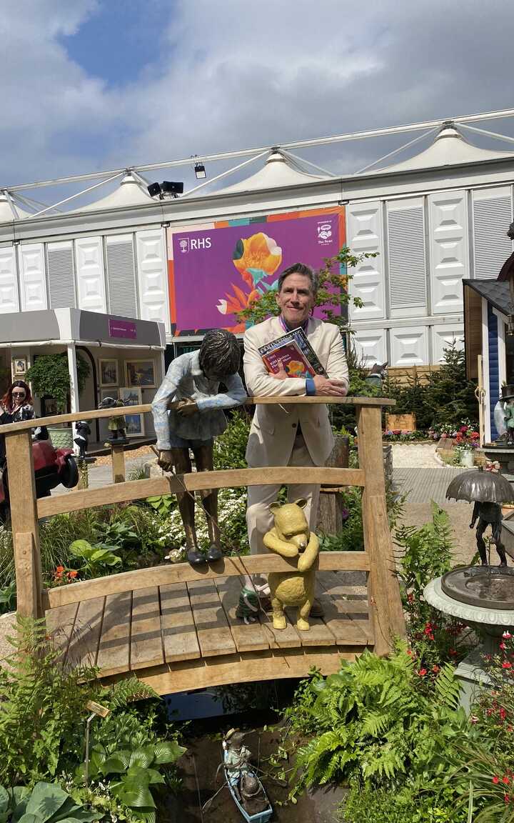 Rob Brydon standing on the Poohsticks Bridge at RHS Chelsea Flower Show 2025