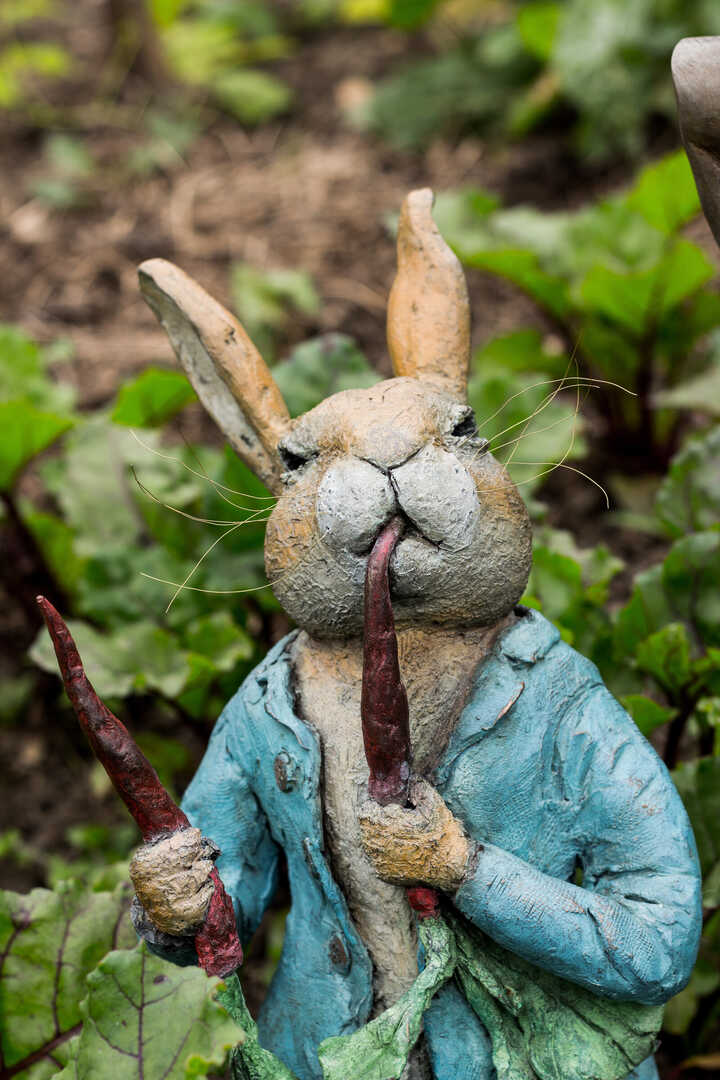 Peter Rabbit Eating Radishes bronze garden sculpture
