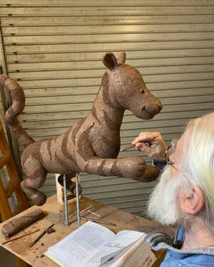 Robert from Robert James Workshop crafting clay Tigger model