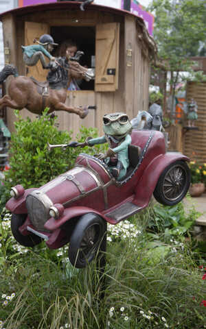 Rob Brydon standing on the Poohsticks Bridge at RHS Chelsea Flower Show 2025
