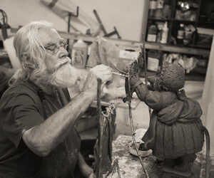 Robert Ellis sculptor at Robert James Workshop working on a Mrs Tiggy Winkle sculpture