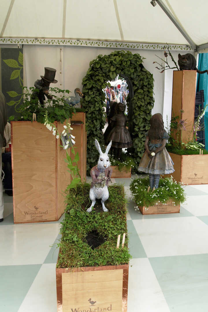 Various bronze garden sculptures on display at RHS Chelsea Flower Show including the White Rabbit, Alice in Wonderland and the Mad Hatter, all created by Robert James Workshop