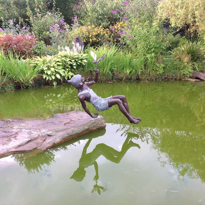 Peter Pan and Tinker Bell sculpture installed on the pond