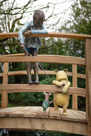 Winnie the Pooh, Piglet, and Christopher Robin, look over the Poohsticks Bridge - A garden sculpture from Robert James Workshop