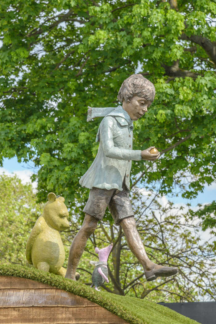 christopher robin sculpture with winnie the pooh and piglet