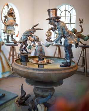 Bronze garden sculptures and water features in the Robert James Workshop Gallery including Mad Hatter Tea Party Urn, Peter Pan, Queen of Hearts, Alice and Flamingo and more