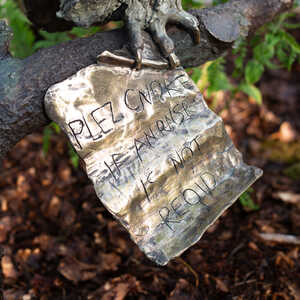 Note attatched to Wol's claws, from Robert James Workshop garden sculpture
